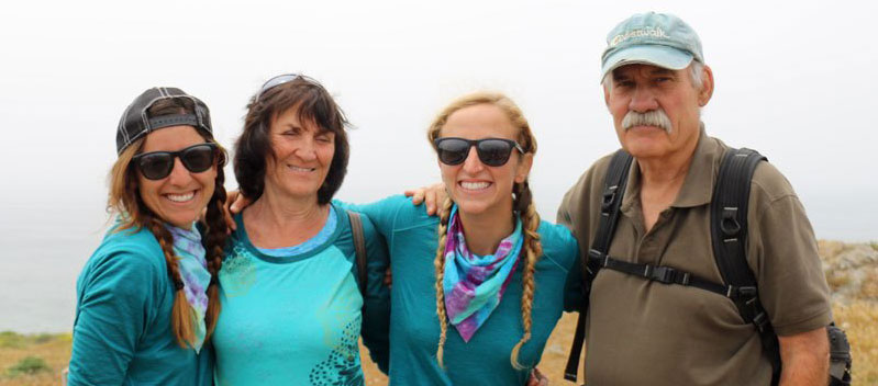 Morgan (Mo)(very left) and Joce (Jo) second from right, interns at the CA coastal trail association, embarked on an expedition from Oregon to Mexico on the California Coastal Trail in the summer of 2016. Richard Nichols, former Executive Director of Coastwalk California and one of the 1996 CCT thru-hikers and his wife Brenda (second from left) met up with them along the trail and shared their favorite memories of Coastwalk in its heyday and told Jo an Mo about the founder of Coastwalk, Bill Kortum, who was a coastal access activist and environmentalist. Image: coastwalk.org